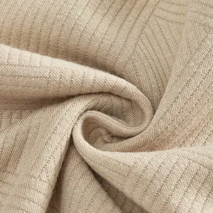 Close-up detail of the heavy-weight jacquard fabric on this beige vintage men's sweatshirt.