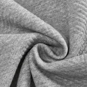 Close-up of grey heavyweight sweatshirt fabric showing detailed jacquard texture
