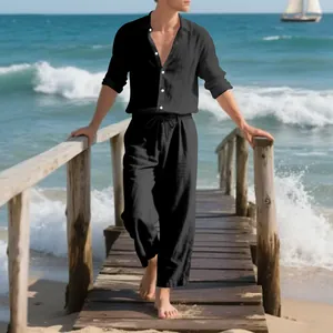 Full body lifestyle shot of the black linen set on a wooden pier by the ocean