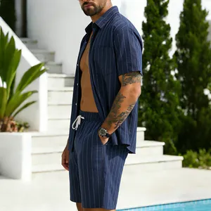 Detailed view of men's navy blue striped linen shirt and shorts set in a resort setting