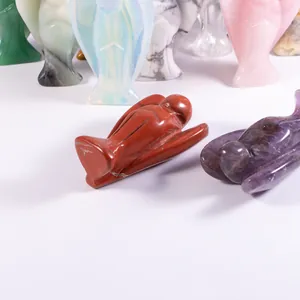 Detailed view of hand-carved natural crystal stone angel figurines in various colors