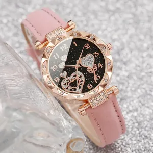 Detailed view of women's starry heart watch with pink leather strap and diamond bezel