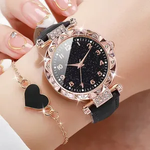 Close-up showing the starry sky dial, sparkling rhinestones, and leather strap detail.