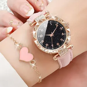 Close-up view of elegant rhinestone watch with starry dial and pink leather strap.