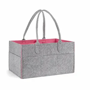 Vista detallada de bolsa de pañales de fieltro gris con interior rosa y medidas 33x23x18.