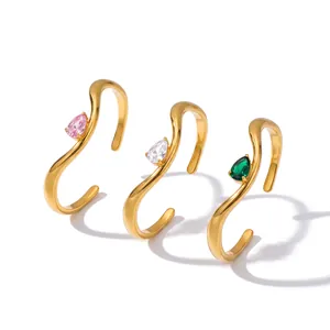Minimalist wave-shaped gold stainless steel bangles with pink, white, and green teardrop zircon