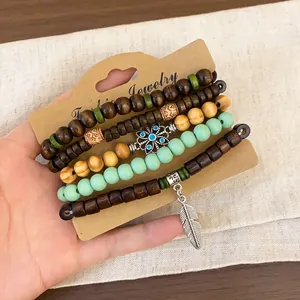 Handheld set of 5 vintage ethnic wood and turquoise beaded bracelets with leaf charm