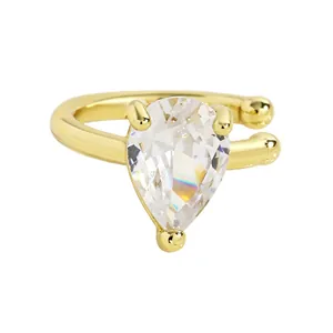 Macro view of teardrop shaped crystal ear cuff with elegant golden metallic finish