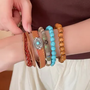 Set van vijf armbanden in boheemse stijl met houten kralen en turkoois stenen aan pols