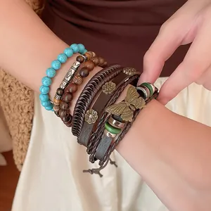 Detailopname van bohemian gelaagde armbanden met houten kralen en mooie vlinderbedels