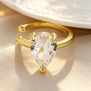 Macro view of a luxury teardrop zircon ear cuff with a gold-plated twisted band.