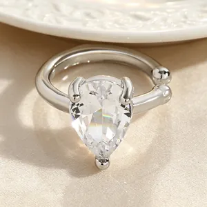 Close-up view of pear-shaped zircon ear cuff with twisted silver-tone metal