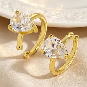 Detailed view of luxury gold-tone ear clips with pear-shaped cubic zirconia stones