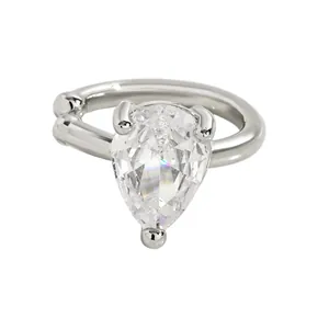 Detailed macro view of a silver-tone ear cuff featuring a large pear-shaped zircon stone.