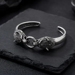 Detailed view of vintage double wolf head stainless steel cuff bracelet for men