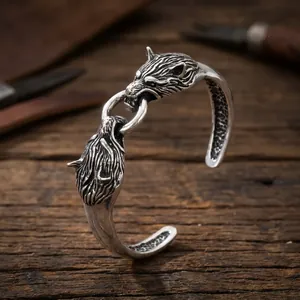 Detailed view of vintage wolf head design on oxidized silver-tone men's cuff bracelet