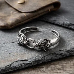 Close-up of double wolf head stainless steel cuff bracelet with vintage punk finish.