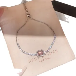 Elegant silver-toned bracelet with pink rectangular stone and sparkling zircons