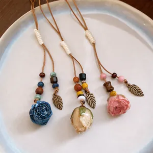 Handmade leather cord necklace with preserved flower and wooden bead leaf charms