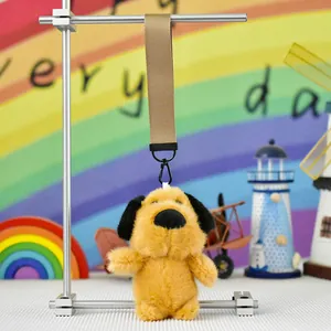 Detailed close-up of a cute yellow plush puppy keychain hanging in a colorful scene