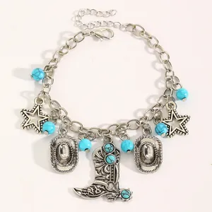 Detail of a western style charm bracelet with turquoise beads and cowboy boot pendant