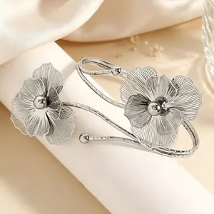 Exaggerated silver hollow metal flower upper arm cuff with an elegant pansy design