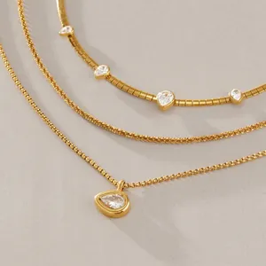 Close-up view of 18k gold plated titanium steel necklaces with teardrop cubic zirconia.