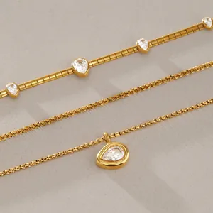 Detailed view of three 18k gold-plated stainless steel necklaces with pear-cut zircons
