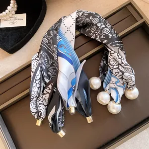 Vue détaillée d'un collier en foulard de soie français avec pendentifs magnétiques.
