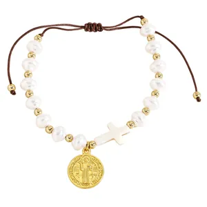 Detailed view of handmade pearl bracelet with Saint Benedict medal and cross