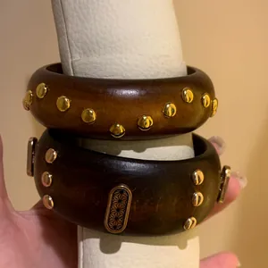 Vintage wide wooden bangles with gold studs and engraved metal plate detail