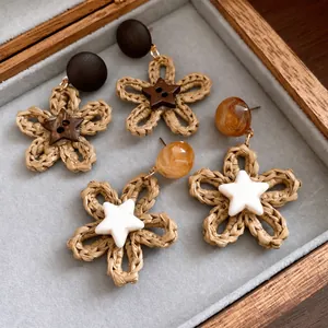 Bohemian handwoven paper rope flower earrings with star accents in a wooden gift box