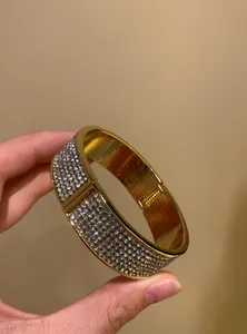 Detailed view of a vintage gold-tone wide bangle encrusted with shimmering rhinestones