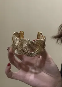 Detail shot of vintage style gold-tone woven wide cuff bracelet with textured wire design