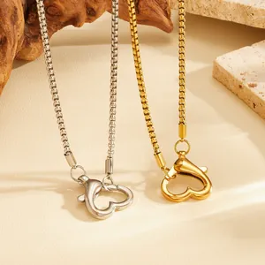 Detailed view of heart-shaped lobster clasp necklaces in gold and silver stainless steel