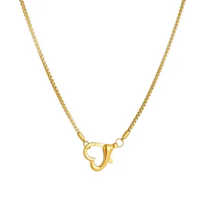 Close-up of French gold PVD plated heart-shaped carabiner clasp on stainless steel necklace
