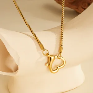Detailed view of a gold heart-shaped carabiner clasp on a stainless steel box chain.