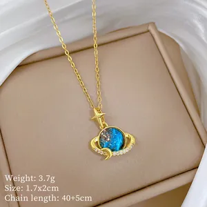 Detail of starry planet pendant with blue galaxy stone and gold titanium chain.