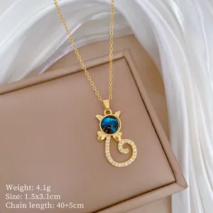 Detailed view of dainty gold cat pendant necklace with blue starry stone and crystals