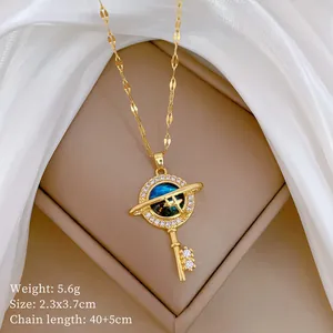 Detail shot of a luxury gold-toned starry sky stone key pendant necklace with sparkling crystals