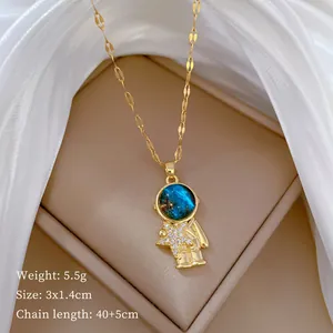 Detail view of golden astronaut necklace with galaxy stone and sparkling star pendant.