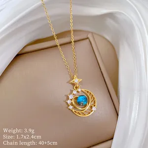 Detailed view of the star and moon pendant with a blue star stone and sparkling crystals