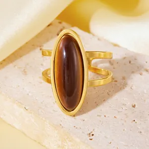 Close-up of a large oval tiger's eye stone ring with 18K gold-plated double band detail