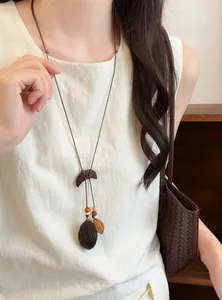 Detailed macro view of a forest-style wooden plant fruit pendant ethnic necklace