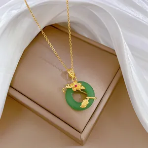 Detailed view of an elegant emerald green pendant necklace on a jewelry display box