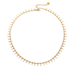 Detail view of gold stainless steel tassel choker necklace with textured bar pendants