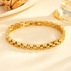 Macro view showing the polished gold-plated stainless steel fish scale link bracelet texture