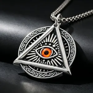 Detailed macro shot of vintage stainless steel All-Seeing Eye pendant with amber cat-eye stone