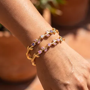 Close-up detail of 18k gold plated stainless steel branch bracelets with pink zircon