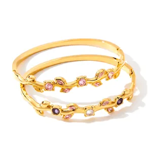 Detail view of 18k gold-plated branch bangles with sparkling colorful cubic zirconia
